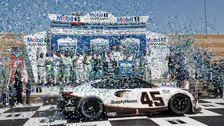 Apr 19, 2026; Kansas City, Kansas, USA; NASCAR Cup Series driver Tyler Reddick (45) and the rest of the team are showered with confetti after Reddick won the AdventHealth 400 at Kansas Speedway.