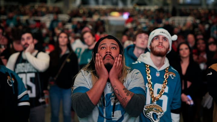 Jacksonville Jaguars fans Griffin Lasch, center, and Garrett Roberson, right, react to costly mistakes during the second half Saturday, Jan 21, 2023 at TIAA Bank Field's Dream Finders Homes Flex Field at Daily's Place in Jacksonville, Fla. 