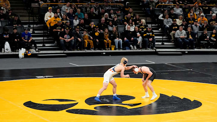 Iowa’s Michael Caliendo wrestles Illinois’ Braeden Scoles in a 165-pound match Friday, Jan. 17, 2025 at Carver-Hawkeye Arena in Iowa City, Iowa.