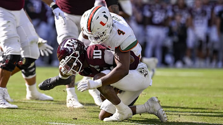 Dec 20, 2025; College Station, TX, USA; Miami Hurricanes defensive lineman Rueben Bain Jr. (4) sacks Texas A&M Aggies quarterback Marcel Reed (10) during the game between the Aggies and the Hurricanes at Kyle Field. Mandatory Credit: Jerome Miron-Imagn Images