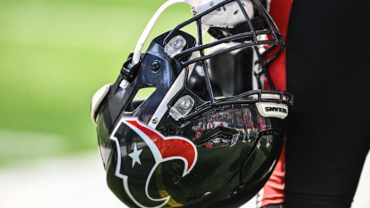 Sep 22, 2024; Minneapolis, Minnesota, USA; A Houston Texans player holds onto his helmet from the sideline during the game against the Minnesota Vikings at U.S. Bank Stadium. Mandatory Credit: Jeffrey Becker-Imagn Images