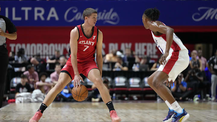 Jul 12, 2024; Las Vegas, NV, USA;  Atlanta Hawks forward/guard Nikola Durisic (7) controls the ball against Washington Wizards guard Bub Carrington (17) during the first half at Thomas & Mack Center. Mandatory Credit: Lucas Peltier-Imagn Images