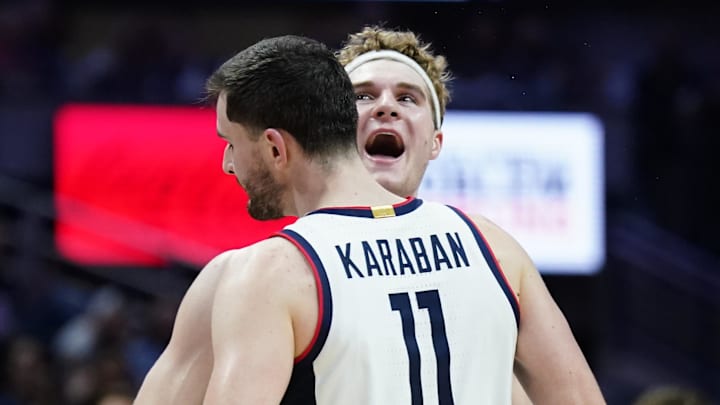 Nov 6, 2024; Storrs, Connecticut, USA; Connecticut Huskies forward Liam McNeeley (30) and forward Alex Karaban (11) react after a play against the Sacred Heart Pioneers in the second half at Harry A. Gampel Pavilion. Mandatory Credit: David Butler II-Imagn Images