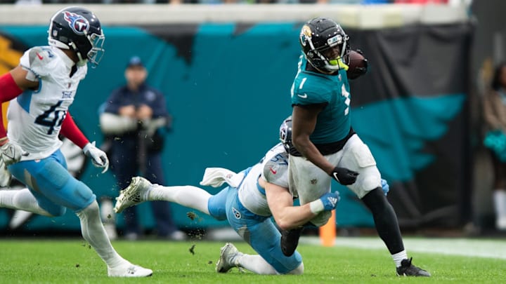 Dec 29, 2024; Jacksonville, Florida, USA; Tennessee Titans linebacker Luke Gifford (57) tackles Jacksonville Jaguars running back Travis Etienne Jr (1) in the fourth quarter at EverBank Stadium. Mandatory Credit: Jeremy Reper-Imagn Images