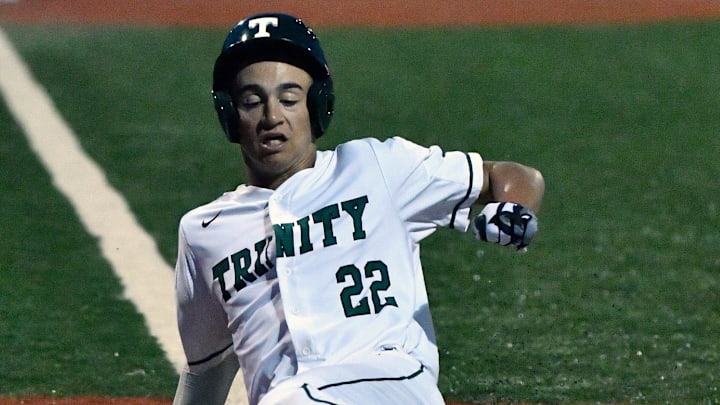 Trinity Christian's Korbyn Dickerson scores during a 7th region championship game against St. Xavier on May 28, 2019, at Eastern High School.
