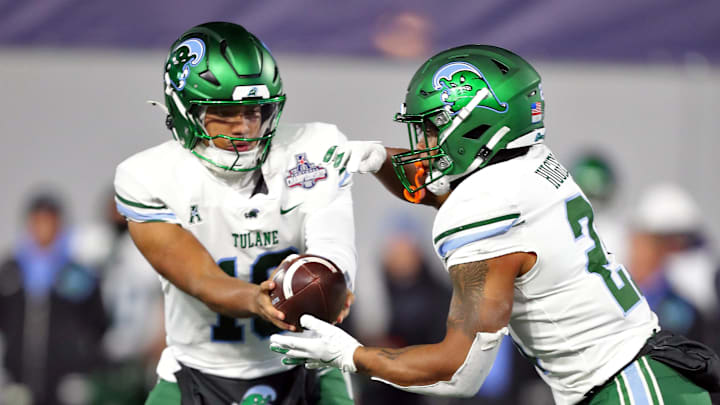 Dec 6, 2024; West Point, NY, USA; Tulane Green Wave quarterback Darian Mensah (10) hands off the ball to running back Shaadie Clayton-Johnson (2) during the first half against the Army Black Knights at Michie Stadium.