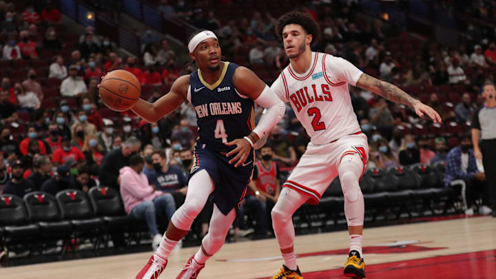 Oct 8, 2021; Chicago, Illinois, USA; New Orleans Pelicans guard Devonte' Graham (4) drives past Chicago Bulls guard Lonzo Ball (2) during the first quarter at the United Center.