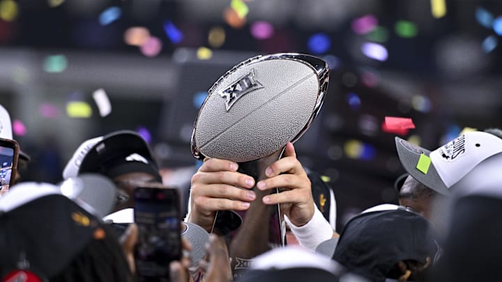 Dec 7, 2024; Arlington, TX, USA; The Arizona State Sun Devils team celebrate with the trophy after the Sun Devils defeat the Iowa State Cyclones and win the 2024 Big 12 Championship at AT&T Stadium. Mandatory Credit: Jerome Miron-Imagn Images