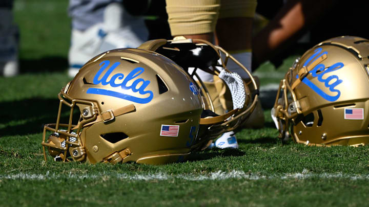 Nov 30, 2024; Pasadena, California, USA; UCLA Bruins helmets during pregame warmups before playing the Fresno State Bulldogs at Rose Bowl. Mandatory Credit: Robert Hanashiro-Imagn Images
