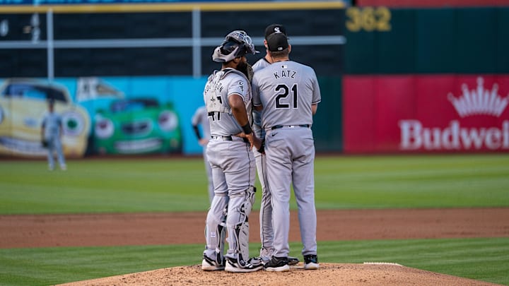 Chicago White Sox pitching coach Ethan Katz (21) comes out to talk with Chicago White Sox starting pitcher Ky Bush (57) during the first inning against the Oakland Athletics at Oakland-Alameda County Coliseum. Mandatory Credit: Neville E. Guard-Imagn Images