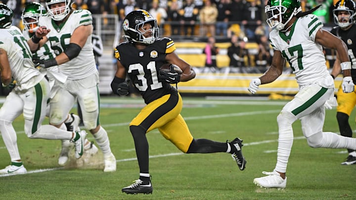 Oct 20, 2024; Pittsburgh, Pennsylvania, USA; Pittsburgh Steelers cornerback Beanie Bishop Jr. (31) returns an interception while being chased by New York Jets wide receiver Davante Adams (17) during the third quarter at Acrisure Stadium. Mandatory Credit: Barry Reeger-Imagn Images