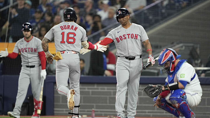 Apr 29, 2025; Toronto, Ontario, CAN; Boston Red Sox designated hitter Rafael Devers (11) congratulates eft fielder Jarren Duran (16) after hitting a solo home run against the Toronto Blue Jays during the first inning at Rogers Centre. Mandatory Credit: John E. Sokolowski-Imagn Images