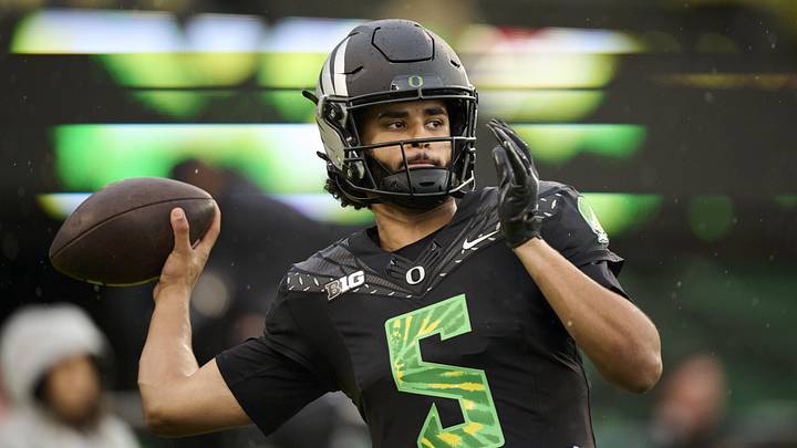 Oct 25, 2025; Eugene, Oregon, USA; Oregon Ducks quarterback Dante Moore (5) warms up before a game against the Wisconsin Badgers at Autzen Stadium. The Ducks are wearing uniforms celebrating the Grateful Dead. Mandatory Credit: Troy Wayrynen-Imagn Images Oct 25, 2025; Eugene, Oregon, USA; Oregon Ducks quarterback Dante Moore (5) warms up before a game against the Wisconsin Badgers at Autzen Stadium. The Ducks are wearing uniforms celebrating the Grateful Dead. Mandatory Credit: Troy Wayrynen-Imagn Images