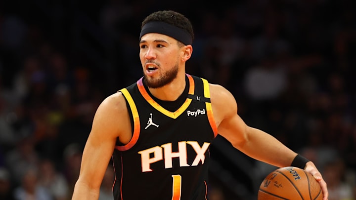Dec 3, 2024; Phoenix, Arizona, USA; Phoenix Suns guard Devin Booker (1) against the San Antonio Spurs during an NBA Cup game at Footprint Center. Mandatory Credit: Mark J. Rebilas-Imagn Images