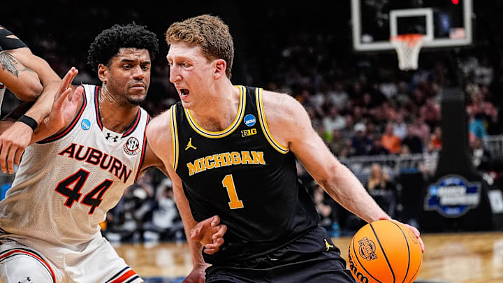 Michigan center Danny Wolf (1) dribbles against Auburn center Dylan Cardwell (44) during the first half of the Sweet 16 round of NCAA tournament at State Farm Arena in Atlanta, Ga. on Friday, March 28, 2025.