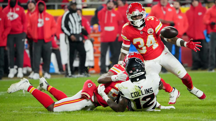 Dec 7, 2025; Kansas City, Missouri, USA; Kansas City Chiefs safety Mike Edwards (34) and Kansas City Chiefs cornerback Nohl Williams (20) break up a pass intended for Houston Texans wide receiver Nico Collins (12) during the second quarter at GEHA Field at Arrowhead Stadium. Mandatory Credit: Denny Medley-Imagn Images