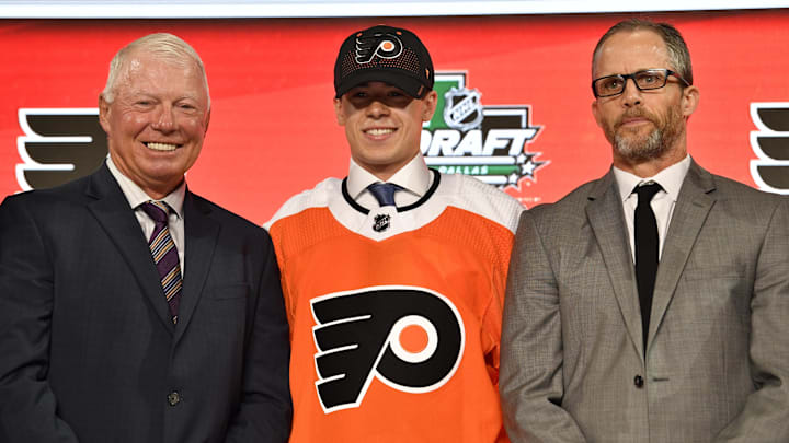 Jun 22, 2018; Dallas, TX, USA; Jay O'Brien poses for a photo with team representatives after being selected as the number nineteen overall pick to the Philadelphia Flyers in the first round of the 2018 NHL Draft at American Airlines Center.