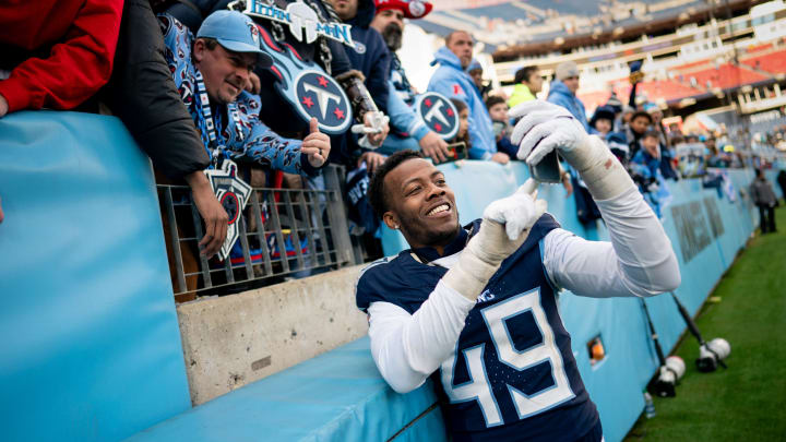 Tennessee Titans linebacker Arden Key (49) takes a selfie with fans after defeating Jacksonville Jaguars 28-20 at Nissan Stadium in Nashville, Tenn., Sunday, Jan. 7, 2024.
