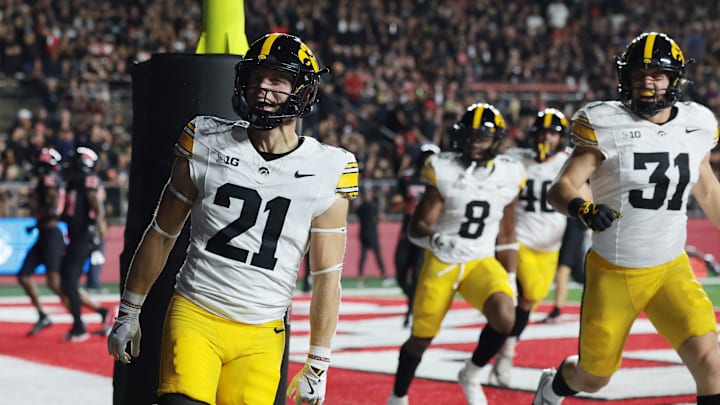 Sep 19, 2025; Piscataway, New Jersey, USA; Iowa Hawkeyes wide receiver Kaden Wetjen (21) celebrates with teammates after returning the opening kickoff for a touchdown during the first quarter against the Rutgers Scarlet Knights at SHI Stadium. Mandatory Credit: Vincent Carchietta-Imagn Images