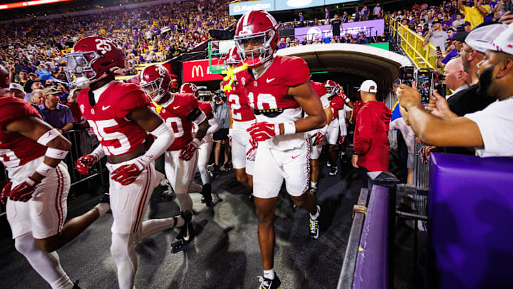 Nov 9, 2024; Baton Rouge, Louisiana, USA;  Alabama Crimson Tide players run onto the field before their game against the LSU Tigers at Tiger Stadium. Mandatory Credit: Stephen Lew-Imagn Images