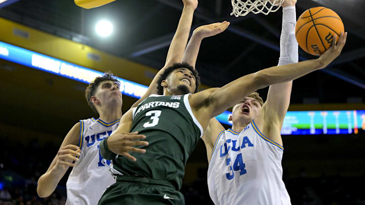 Feb 4, 2025; Los Angeles, California, USA; Michigan State Spartans guard Jaden Akins (3) scores past the defense of UCLA Bruins center Aday Mara (15) and forward Tyler Bilodeau (34) in the second half at Pauley Pavilion presented by Wescom. Mandatory Credit: Jayne Kamin-Oncea-Imagn Images Feb 4, 2025; Los Angeles, California, USA; Michigan State Spartans guard Jaden Akins (3) scores past the defense of UCLA Bruins center Aday Mara (15) and forward Tyler Bilodeau (34) in the second half at Pauley Pavilion presented by Wescom. Mandatory Credit: Jayne Kamin-Oncea-Imagn Images