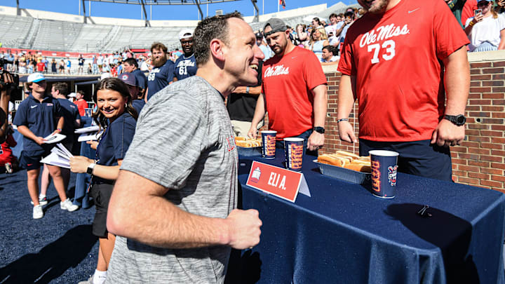 Joey Chestnut, left, greets Ole Miss offensive lineman Eli Acker (73) during the Ole Miss Grove Bowl Games at Vaught-Hemingway Stadium in Oxford, Miss., on Saturday, Apr. 13, 2024.