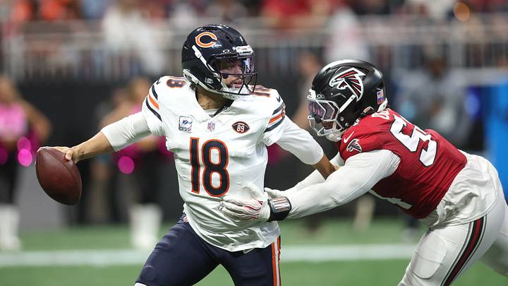 Chicago Bears quarterback Caleb Williams (18) eludes the Atlanta Falcons rush during the second quarter at Mercedes-Benz Stadium. Mandatory Credit: Brett Davis-Imagn Images Chicago Bears quarterback Caleb Williams (18) eludes the Atlanta Falcons rush during the second quarter at Mercedes-Benz Stadium. Mandatory Credit: Brett Davis-Imagn Images