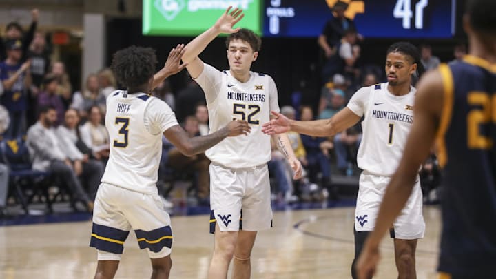 Dec 3, 2025; Morgantown, West Virginia, USA; West Virginia Mountaineers guard Honor Huff (3) celebrates with West Virginia Mountaineers guard Treysen Eaglestaff (52) and West Virginia Mountaineers guard Jasper Floyd (1) during the second half against the Coppin State Eagles at Hope Coliseum. Mandatory Credit: Ben Queen-Imagn Images Dec 3, 2025; Morgantown, West Virginia, USA; West Virginia Mountaineers guard Honor Huff (3) celebrates with West Virginia Mountaineers guard Treysen Eaglestaff (52) and West Virginia Mountaineers guard Jasper Floyd (1) during the second half against the Coppin State Eagles at Hope Coliseum. Mandatory Credit: Ben Queen-Imagn Images