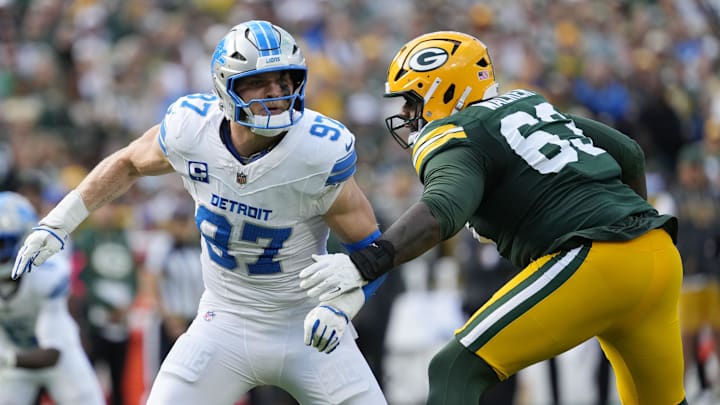 Sep 7, 2025; Green Bay, Wisconsin, USA; Detroit Lions defensive end Aidan Hutchinson (97) fights for position with Green Bay Packers offensive tackle Rasheed Walker (63) during the second quarter at Lambeau Field. Mandatory Credit: Jeff Hanisch-Imagn Images