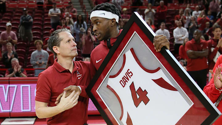 Arkansas Razorbacks head coach Eric Musselman shakes hands with guard Davonte Davis (4) during senior presentations after the game against the LSU Tigers at Bud Walton Arena. Arkansas won 94-83. 