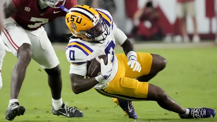 LSU WR Zavion Thomas spins out of a tackle at Saban Field at Bryant-Denny Stadium. Gary Cosby Jr.-Imagn Images