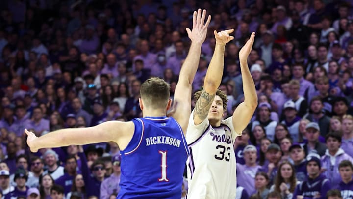 Feb 8, 2025; Manhattan, Kansas, USA; Kansas State Wildcats forward Coleman Hawkins (33) shoots against Kansas Jayhawks center Hunter Dickinson (1) during the first half at Bramlage Coliseum. Mandatory Credit: Scott Sewell-Imagn Images