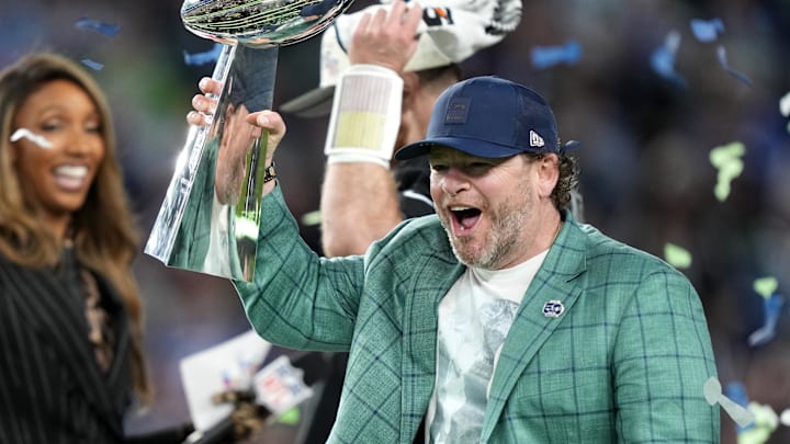 Seattle Seahawks general manager John Schneider celebrates with the Vince Lombardi trophy.