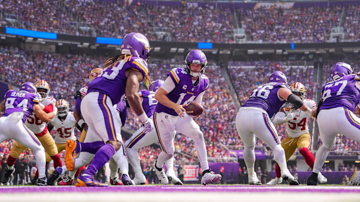 Sep 15, 2024; Minneapolis, Minnesota, USA; Minnesota Vikings quarterback Sam Darnold (14) fakes a hand off to running back Aaron Jones (33) against the San Francisco 49ers in the second quarter at U.S. Bank Stadium. Mandatory Credit: Brad Rempel-Imagn Images