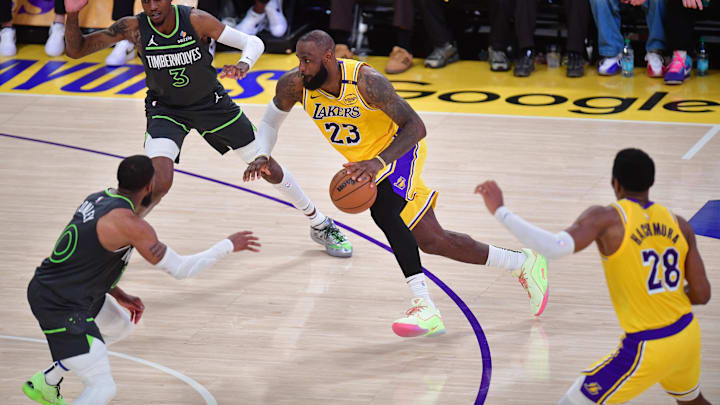 Apr 30, 2025; Los Angeles, California, USA; Los Angeles Lakers forward LeBron James (23) moves to the basket against Minnesota Timberwolves forward Jaden McDaniels (3) and guard Mike Conley (10) during the second half in game five of first round for the 2025 NBA Playoffs at Crypto.com Arena. Mandatory Credit: Gary A. Vasquez-Imagn Images