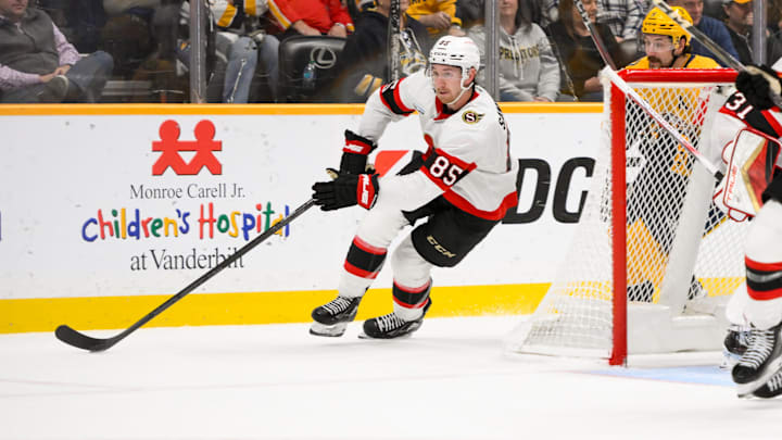 Feb 3, 2025; Nashville, Tennessee, USA; Ottawa Senators defenseman Jake Sanderson (85) skates behind the net against the Nashville Predators during the second period at Bridgestone Arena. Mandatory Credit: Steve Roberts-Imagn Images