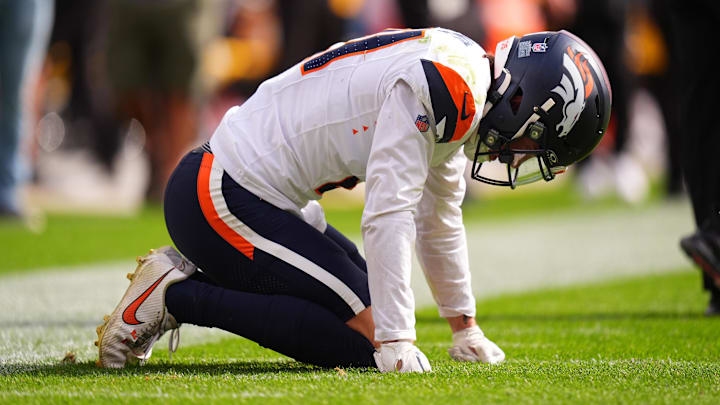Sep 15, 2024; Denver, Colorado, USA; Denver Broncos cornerback Riley Moss (21) reacts to an injury after a tackle in the second quarter against the Pittsburgh Steelers at Empower Field at Mile High. 