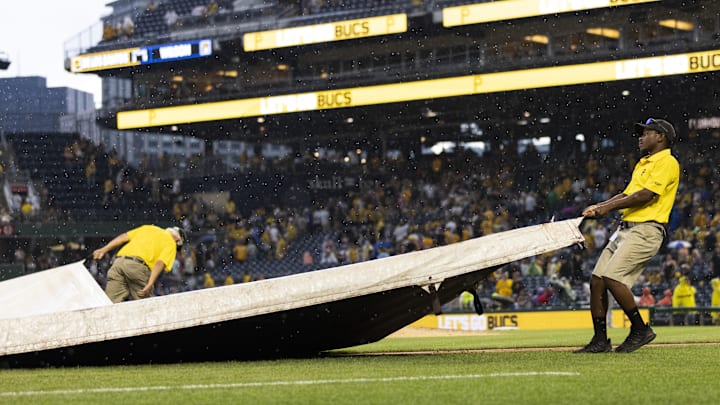 Jul 1, 2023; Pittsburgh, Pennsylvania, USA; The Pittsburgh Pirates grounds crew pulls the tarp onto the field during a rain delay in the ninth inning against the Milwaukee Brewers at PNC Park. Mandatory Credit: Scott Galvin-Imagn Images Jul 1, 2023; Pittsburgh, Pennsylvania, USA; The Pittsburgh Pirates grounds crew pulls the tarp onto the field during a rain delay in the ninth inning against the Milwaukee Brewers at PNC Park. Mandatory Credit: Scott Galvin-Imagn Images