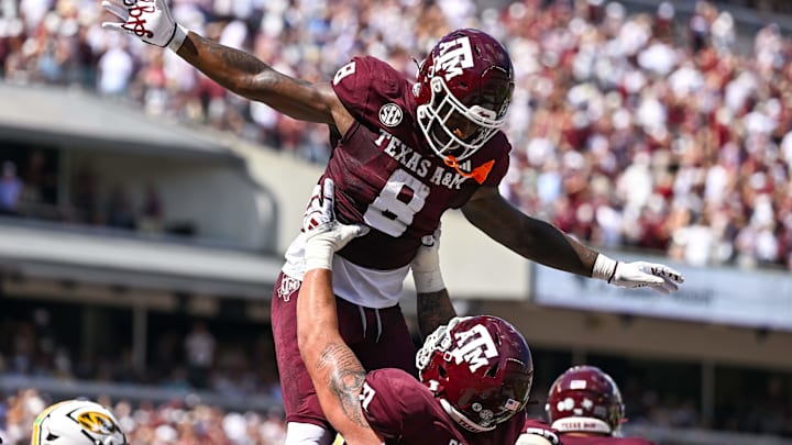 Oct 5, 2024; College Station, Texas, USA; Texas A&M Aggies running back Le'Veon Moss (8) celebrates with offensive lineman Chase Bisontis (71) after scoring a touchdown in the second quarter against the Missouri Tigers at Kyle Field. Oct 5, 2024; College Station, Texas, USA; Texas A&M Aggies running back Le'Veon Moss (8) celebrates with offensive lineman Chase Bisontis (71) after scoring a touchdown in the second quarter against the Missouri Tigers at Kyle Field.