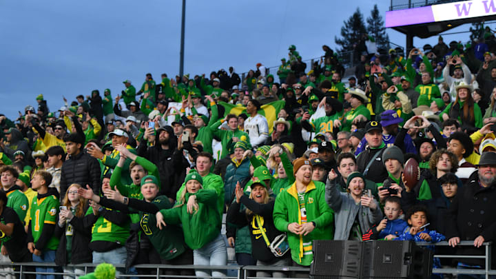 Nov 29, 2025; Seattle, Washington, USA; Oregon Ducks fans celebrate the Ducks defeating the Washington Huskies at Husky Stadium. Mandatory Credit: Steven Bisig-Imagn Images Nov 29, 2025; Seattle, Washington, USA; Oregon Ducks fans celebrate the Ducks defeating the Washington Huskies at Husky Stadium. Mandatory Credit: Steven Bisig-Imagn Images