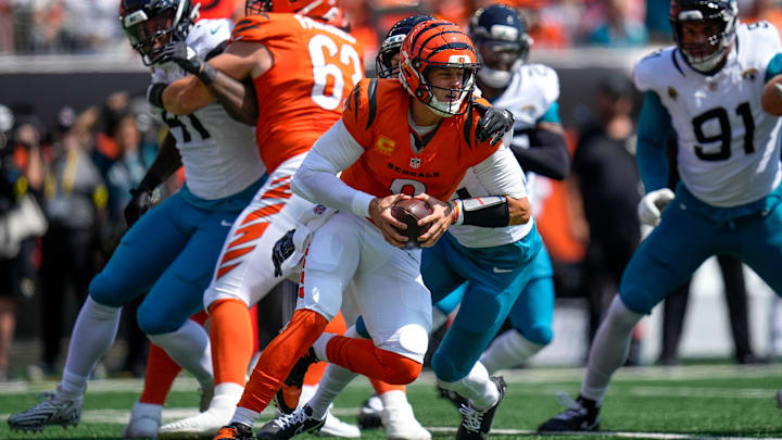 Cincinnati Bengals quarterback Joe Burrow (9) is wrapped up as he scrambles in the first quarter of the NFL Week 2 game between the Cincinnati Bengals and the Jacksonville Jaguars at Paycor Stadium in downtown Cincinnati on Sunday, Sept. 14, 2025. The Jaguars led 17-10 at halftime.
