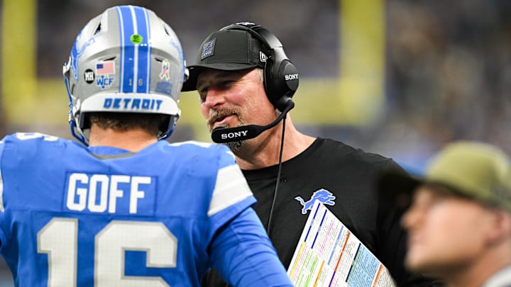 Detroit Lions head coach Dan Campbell speaks with quarterback Jared Goff (16) in the third quarter against the Minnesota Vikings at Ford Field.