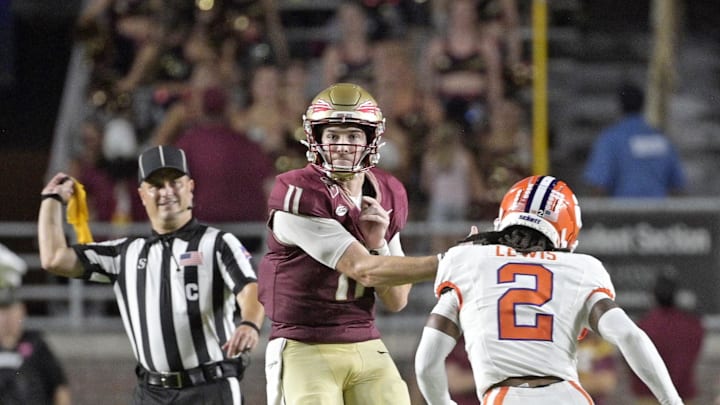 Oct 5, 2024; Tallahassee, Florida, USA; Florida State Seminoles quarterback Brock Glenn (11) throws the ball under pressure against the Clemson Tigers during the second half at Doak S. Campbell Stadium. Mandatory Credit: Melina Myers-Imagn Images