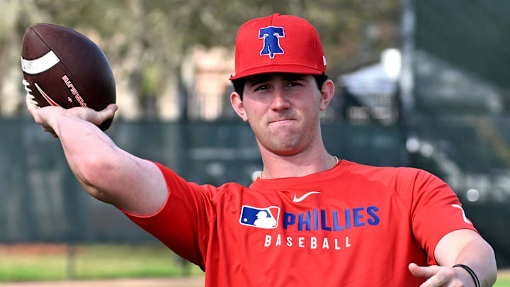 Feb 12, 2025; Clearwater, FL, USA; Philadelphia Phillies pitcher Andrew Painter (76) throws a football during a spring training workout at Carpenter Complex