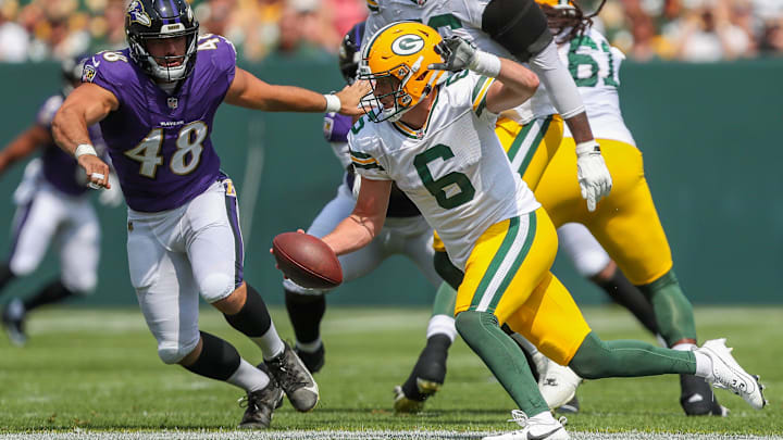 Green Bay Packers quarterback Sean Clifford (6) scrambles away from Baltimore Ravens defensive end Joe Evans (48) during an NFL preseason game on Saturday, August 24, 2024, at Lambeau Field in Green Bay, Wis. 
Tork Mason/USA TODAY NETWORK-Wisconsin