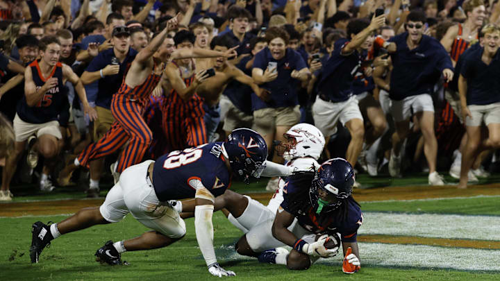 Sep 26, 2025; Charlottesville, Virginia, USA; Virginia Cavaliers defensive back Ja'son Prevard (10) is hugged by Cavaliers defensive back Donavon Platt (28) as fans storm the field after making a game winning interception in the end zone on a pass intended for Florida State Seminoles wide receiver Squirrel White (4) in the second overtime at Scott Stadium. Mandatory Credit: Geoff Burke-Imagn Images