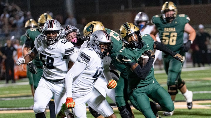 Basha Bears run with the ball against the Hamilton Huskies during a game at Basha High School in Chandler on Oct. 24, 2025.