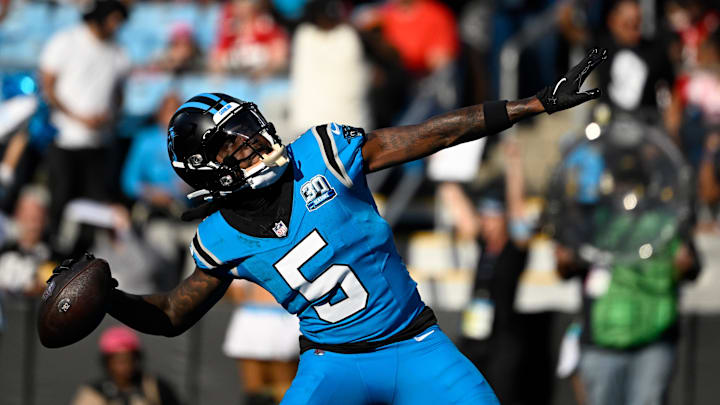 Oct 13, 2024; Charlotte, North Carolina, USA;  Carolina Panthers wide receiver Diontae Johnson (5) celebrates by throwing the ball into the crowd after scoring a thouchdown in the first quarter at Bank of America Stadium. Mandatory Credit: Bob Donnan-Imagn Images