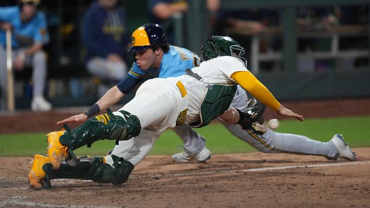 Jun 8, 2026; Summerlin, Nevada, USA; Milwaukee Brewers designated hitter Christian Yelich (22) slides past Athletics catcher Shea Langeliers (23) to home plate during the eleventh inning at the Las Vegas Ballpark. Mandatory Credit: Lucas Peltier-Imagn Images Jun 8, 2026; Summerlin, Nevada, USA; Milwaukee Brewers designated hitter Christian Yelich (22) slides past Athletics catcher Shea Langeliers (23) to home plate during the eleventh inning at the Las Vegas Ballpark. Mandatory Credit: Lucas Peltier-Imagn Images