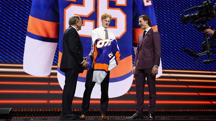Jun 26, 2026; Buffalo, New York, USA; Malte Gustafsson reacts beside NHL commissioner Gary Bettman and New York Islanders player Matthew Schaefer after being selected with the thirteenth pick in the first round of the 2026 NHL Draft by the Islanders at KeyBank Center. Mandatory Credit: Timothy T. Ludwig-Imagn Images
